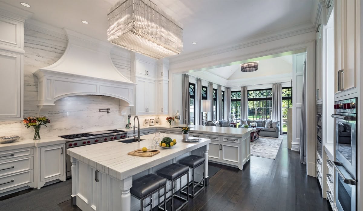 White shaker kitchen remodel with marble island by PJ Restorations
