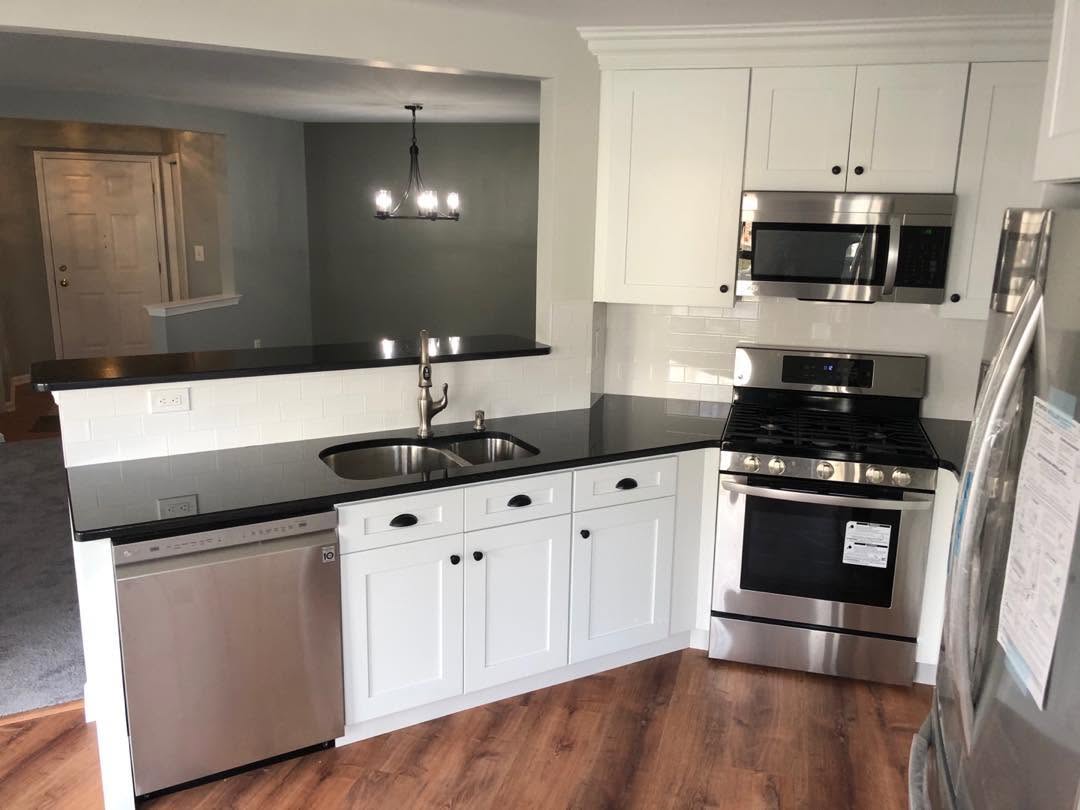 Kitchen remodel with white cabinets and stainless appliances