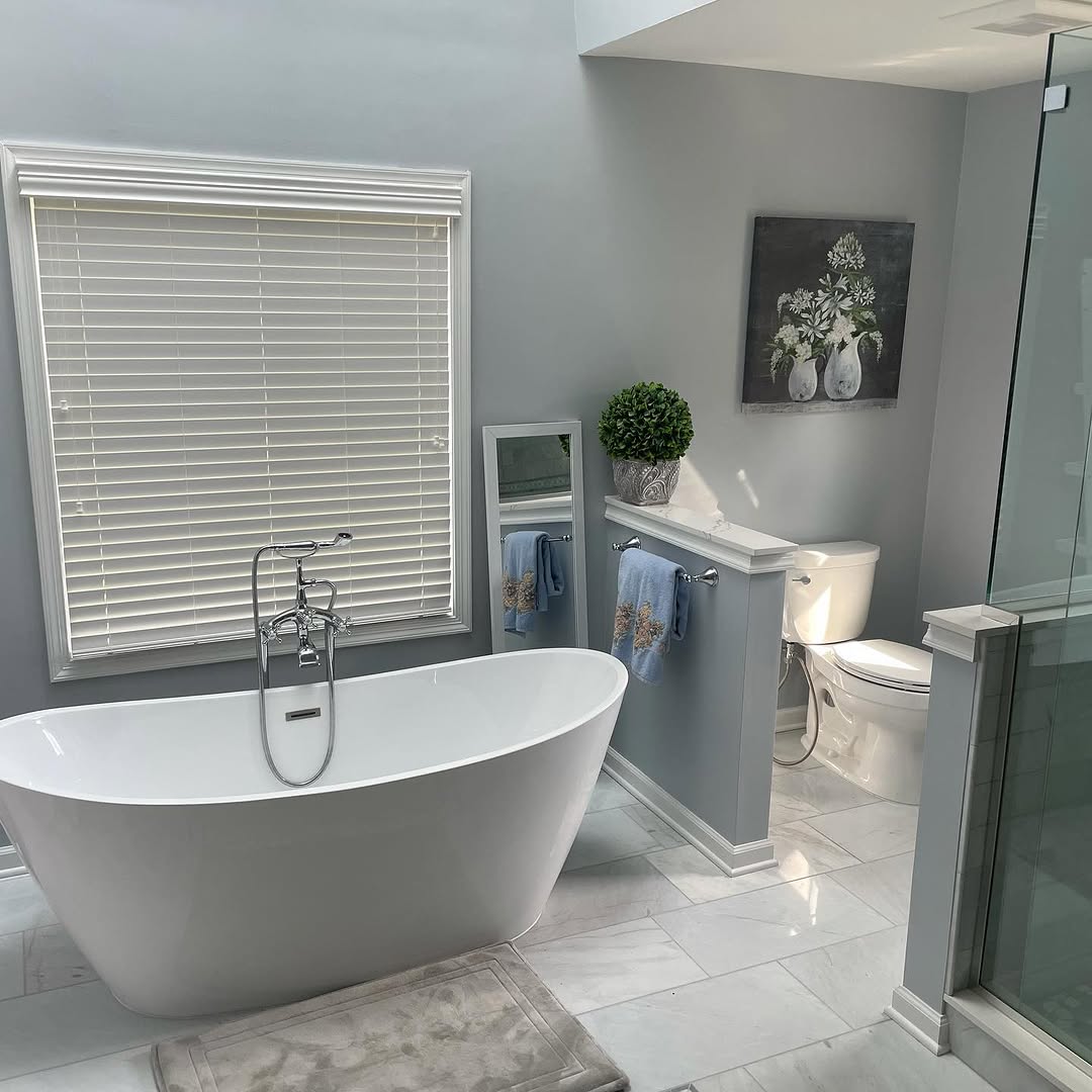 Bathroom remodel with freestanding tub and tile feature wall
